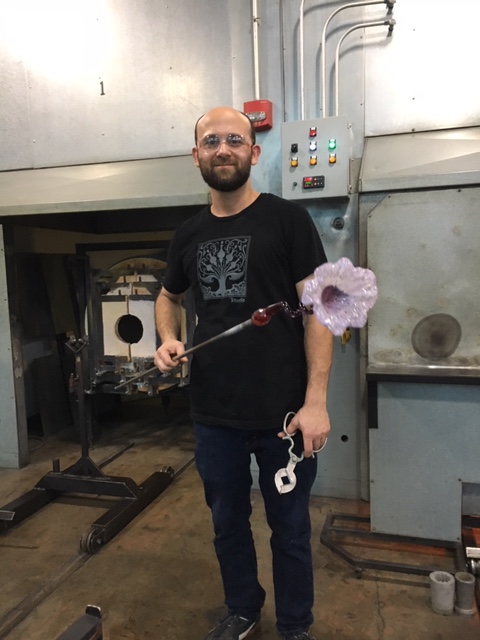 The glassmaker holding the flower I made before putting it in the cooler